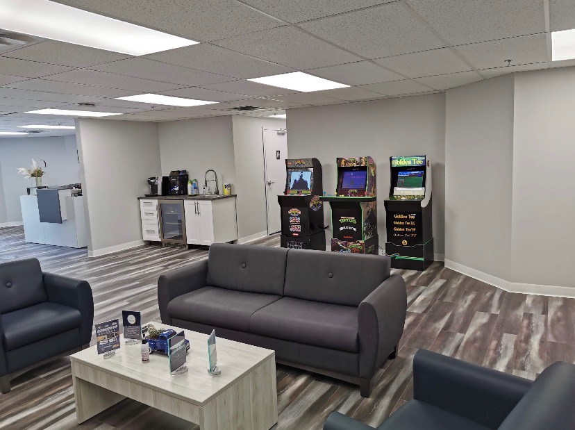 Boulevard Auto Glass Calgary's modern customer lounge, featuring a play area, coffee station, and arcade games to play while you get your windshield replacement or windshield repair done.