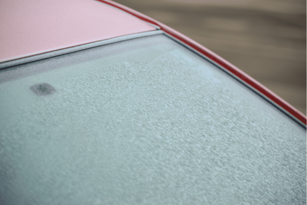 red car with a frosted windshield